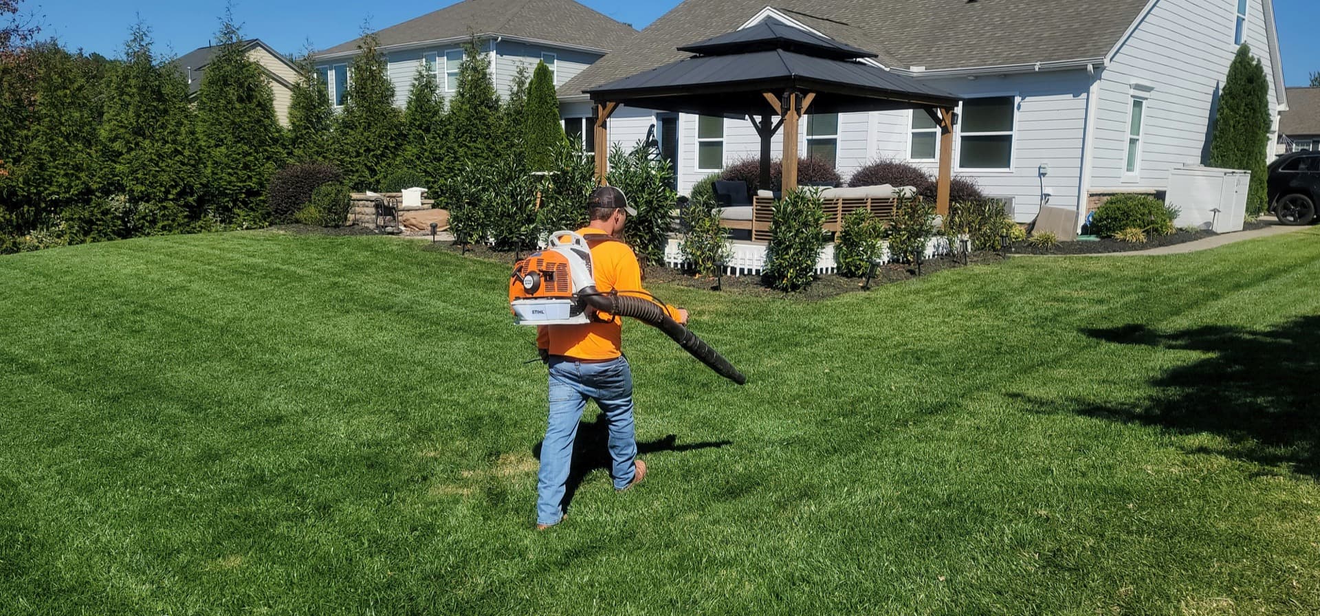 Landscaping worker clearing a residential yard